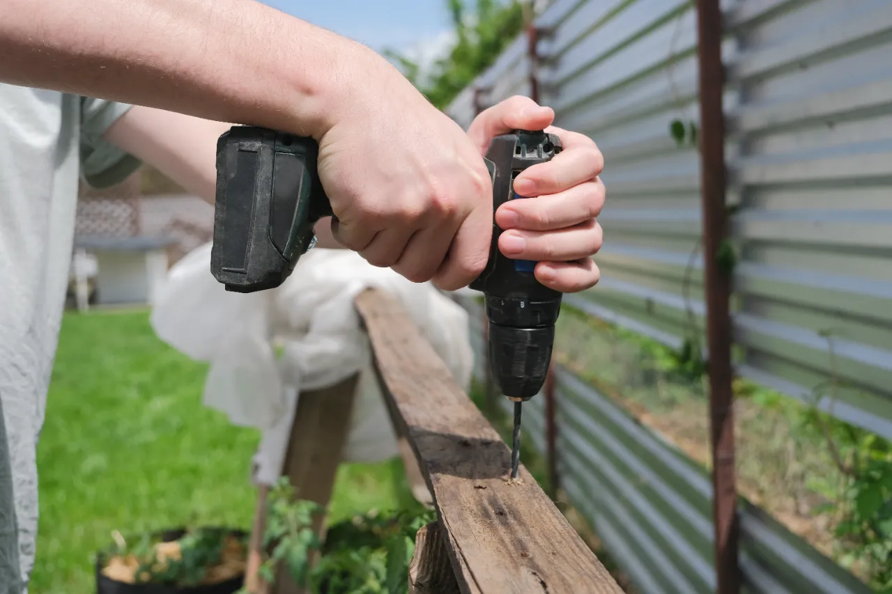 Power drill on fence