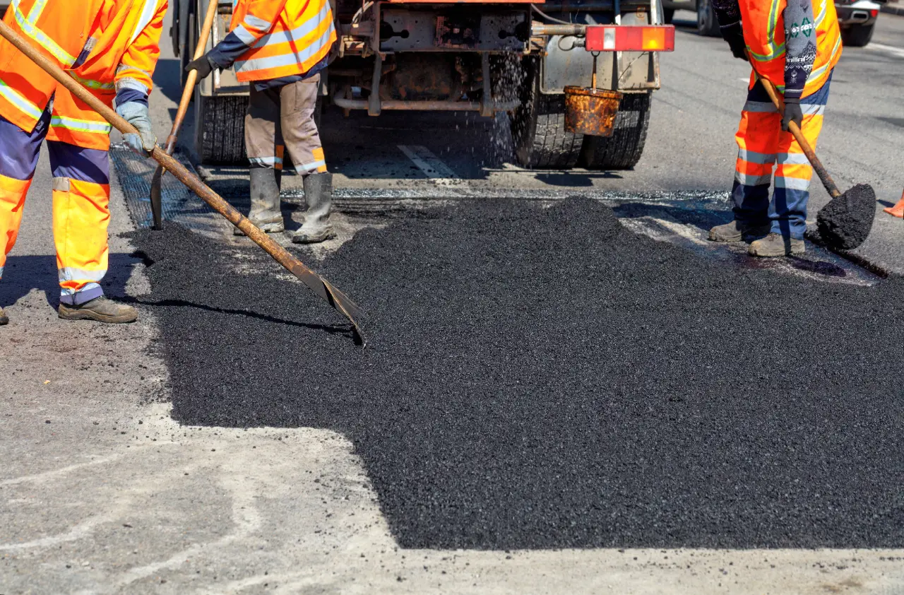 Road workers paving