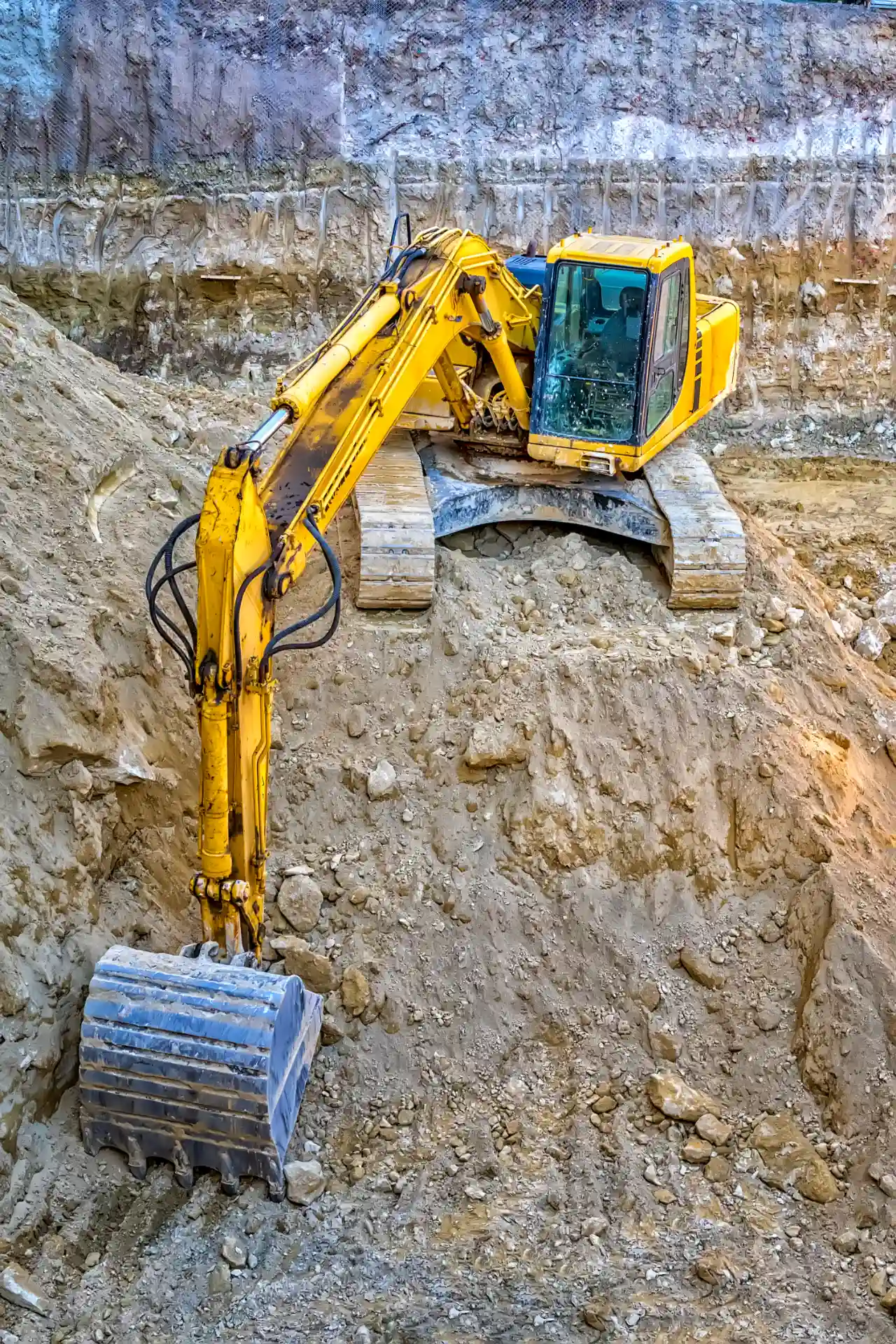 Yellow excavator digging